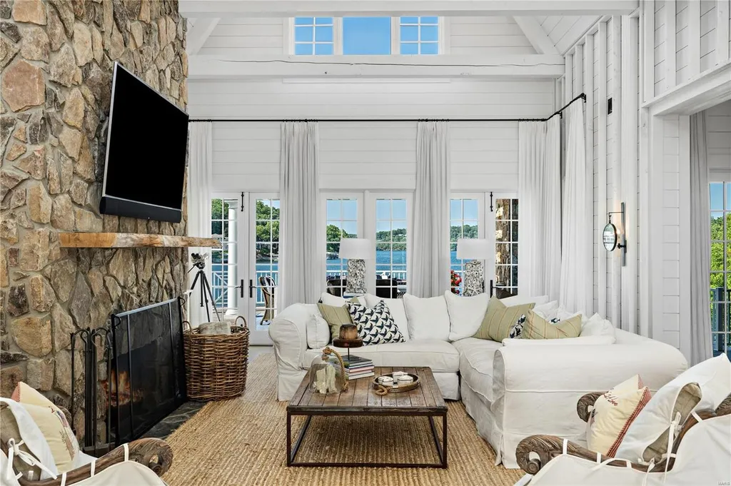 282 Timber Ridge Lane Home in Lake Ozark, Missouri. "Nantucket Point" is the ultimate Crown Jewel of Lake of The Ozarks, offering 1.24 acres of unparalleled beauty with 500' of shoreline, deep water, and breathtaking views. This Nantucket-inspired 6,800 sqft estate exudes laid-back luxury and coastal design, featuring 6 ensuite bedrooms, 2 gourmet kitchens, a gym, game room, and more. 