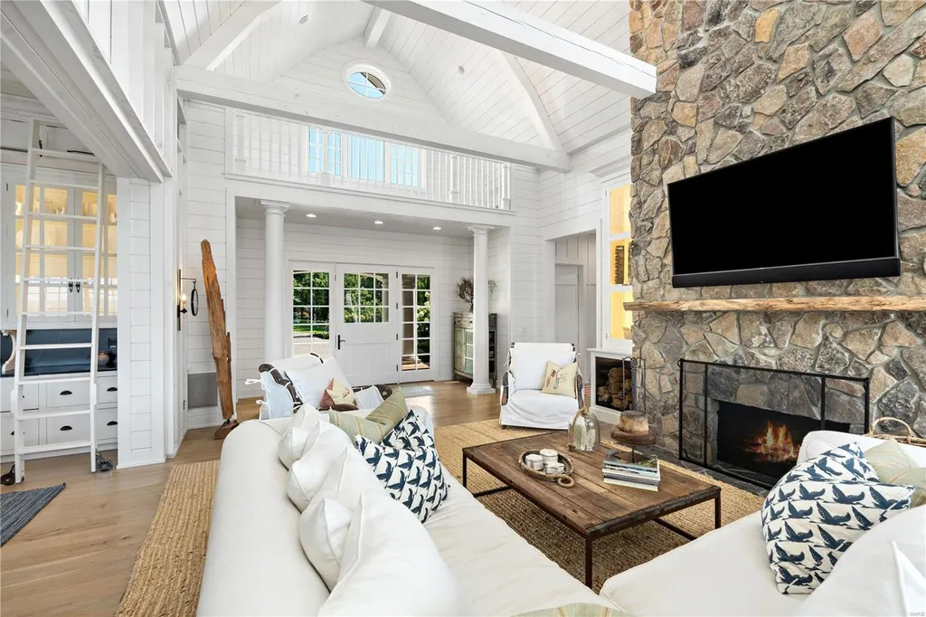 282 Timber Ridge Lane Home in Lake Ozark, Missouri. "Nantucket Point" is the ultimate Crown Jewel of Lake of The Ozarks, offering 1.24 acres of unparalleled beauty with 500' of shoreline, deep water, and breathtaking views. This Nantucket-inspired 6,800 sqft estate exudes laid-back luxury and coastal design, featuring 6 ensuite bedrooms, 2 gourmet kitchens, a gym, game room, and more. 