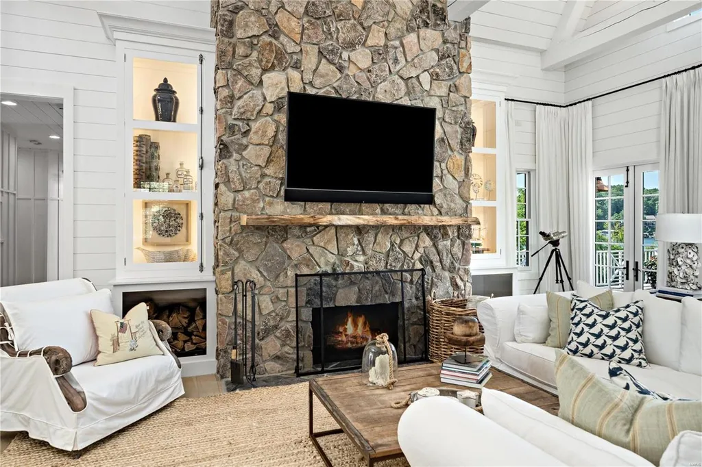 282 Timber Ridge Lane Home in Lake Ozark, Missouri. "Nantucket Point" is the ultimate Crown Jewel of Lake of The Ozarks, offering 1.24 acres of unparalleled beauty with 500' of shoreline, deep water, and breathtaking views. This Nantucket-inspired 6,800 sqft estate exudes laid-back luxury and coastal design, featuring 6 ensuite bedrooms, 2 gourmet kitchens, a gym, game room, and more. 
