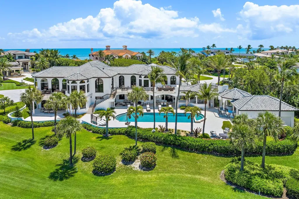 3057 SE Dune Drive Home in Stuart, Florida. Discover this artfully reimagined and fully renovated home boasting panoramic views of a Jack Nicklaus golf course, the lake, and the ocean. Flooded with natural light through 166 windows, the neutral palette accentuates exquisite finishes and architectural details. 