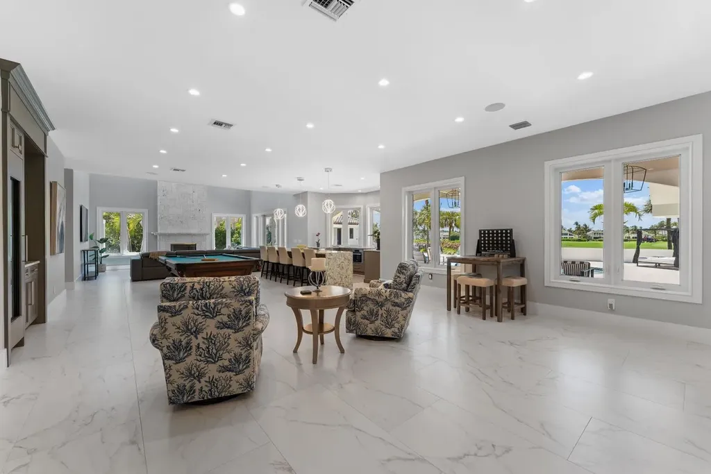 3057 SE Dune Drive Home in Stuart, Florida. Discover this artfully reimagined and fully renovated home boasting panoramic views of a Jack Nicklaus golf course, the lake, and the ocean. Flooded with natural light through 166 windows, the neutral palette accentuates exquisite finishes and architectural details. 