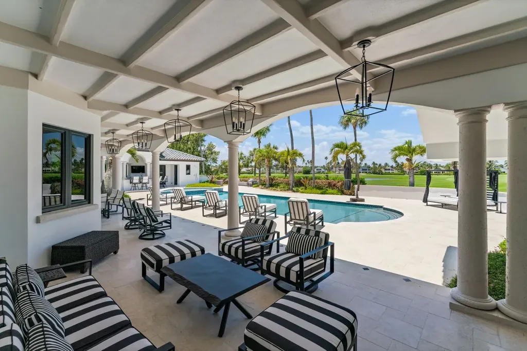 3057 SE Dune Drive Home in Stuart, Florida. Discover this artfully reimagined and fully renovated home boasting panoramic views of a Jack Nicklaus golf course, the lake, and the ocean. Flooded with natural light through 166 windows, the neutral palette accentuates exquisite finishes and architectural details. 