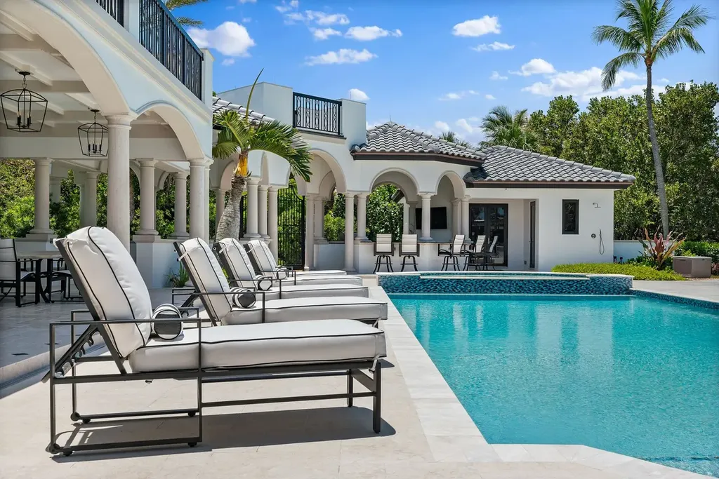 3057 SE Dune Drive Home in Stuart, Florida. Discover this artfully reimagined and fully renovated home boasting panoramic views of a Jack Nicklaus golf course, the lake, and the ocean. Flooded with natural light through 166 windows, the neutral palette accentuates exquisite finishes and architectural details. 