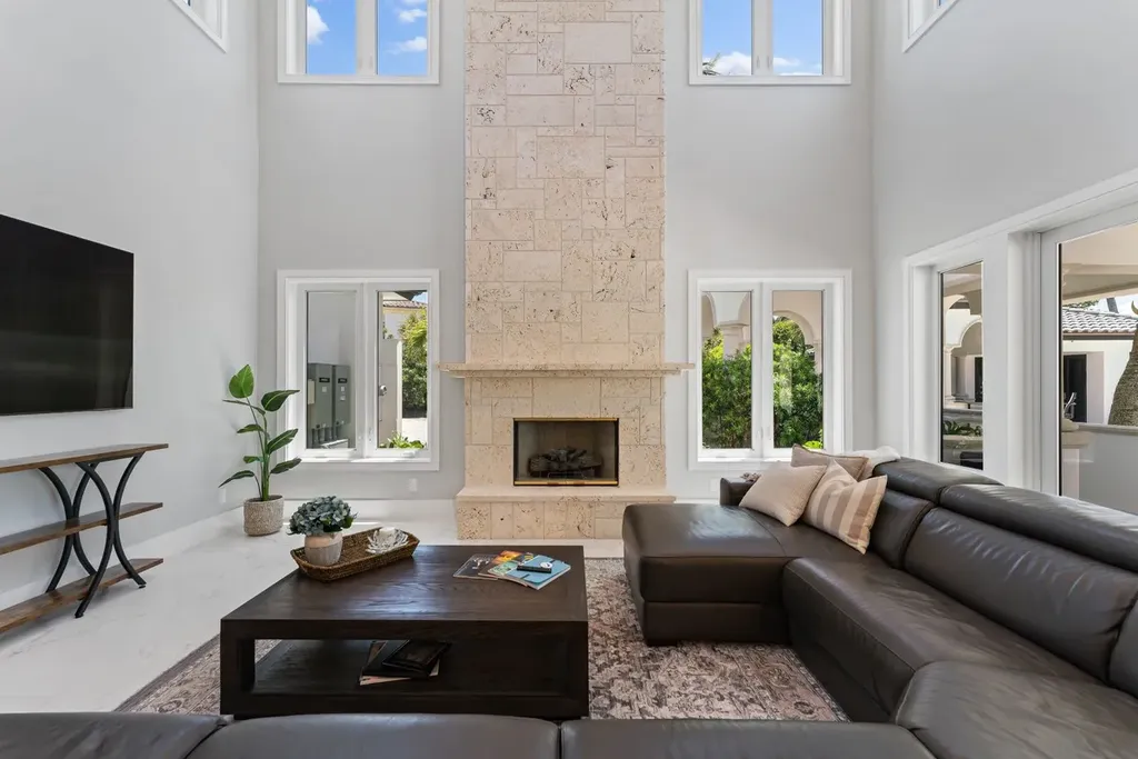 3057 SE Dune Drive Home in Stuart, Florida. Discover this artfully reimagined and fully renovated home boasting panoramic views of a Jack Nicklaus golf course, the lake, and the ocean. Flooded with natural light through 166 windows, the neutral palette accentuates exquisite finishes and architectural details. 