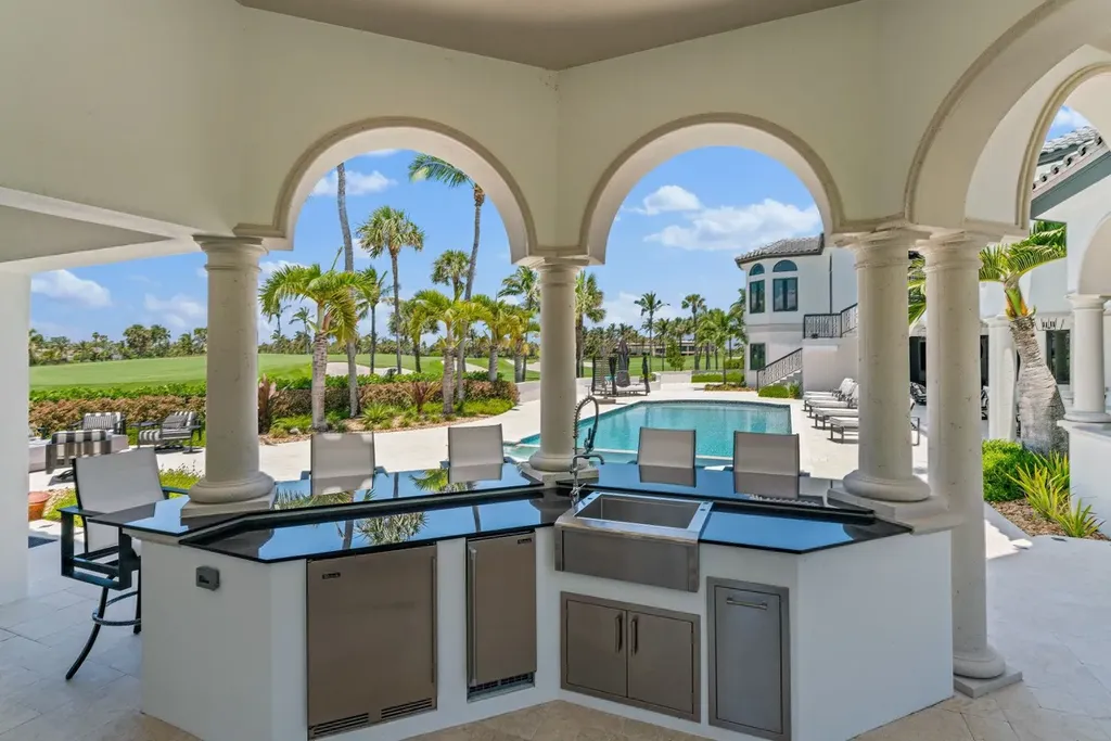3057 SE Dune Drive Home in Stuart, Florida. Discover this artfully reimagined and fully renovated home boasting panoramic views of a Jack Nicklaus golf course, the lake, and the ocean. Flooded with natural light through 166 windows, the neutral palette accentuates exquisite finishes and architectural details. 