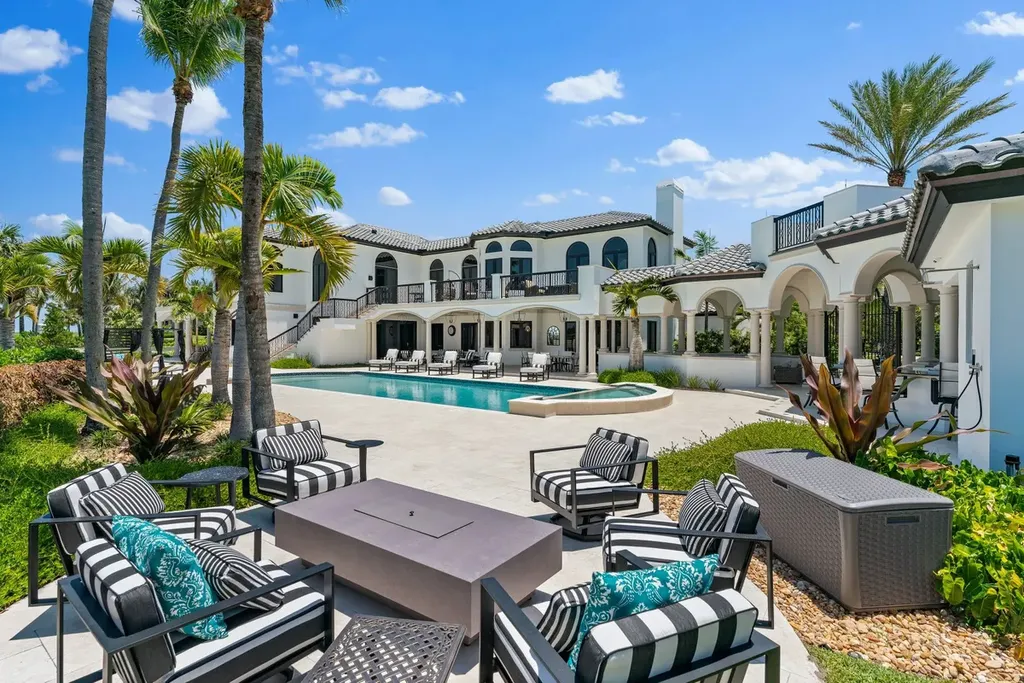 3057 SE Dune Drive Home in Stuart, Florida. Discover this artfully reimagined and fully renovated home boasting panoramic views of a Jack Nicklaus golf course, the lake, and the ocean. Flooded with natural light through 166 windows, the neutral palette accentuates exquisite finishes and architectural details. 