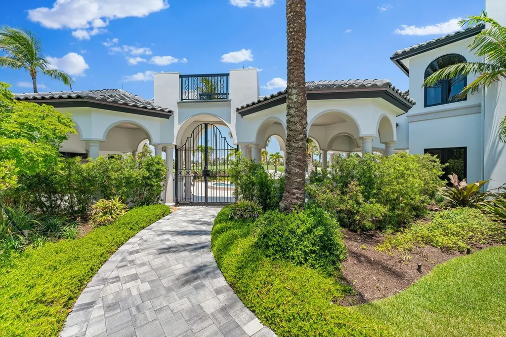 3057 SE Dune Drive Home in Stuart, Florida. Discover this artfully reimagined and fully renovated home boasting panoramic views of a Jack Nicklaus golf course, the lake, and the ocean. Flooded with natural light through 166 windows, the neutral palette accentuates exquisite finishes and architectural details. 