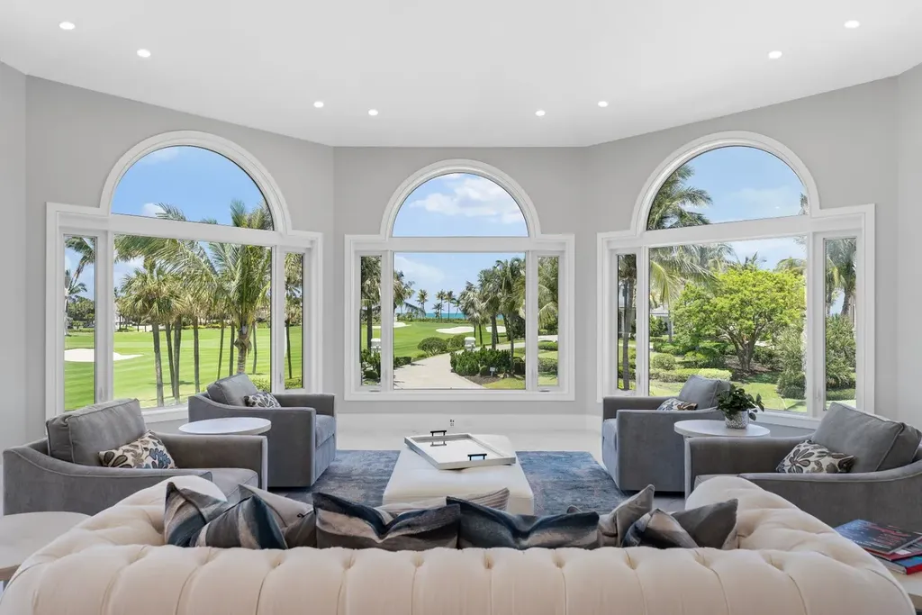 3057 SE Dune Drive Home in Stuart, Florida. Discover this artfully reimagined and fully renovated home boasting panoramic views of a Jack Nicklaus golf course, the lake, and the ocean. Flooded with natural light through 166 windows, the neutral palette accentuates exquisite finishes and architectural details. 