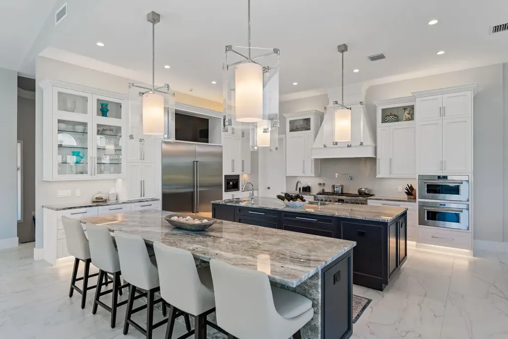 3057 SE Dune Drive Home in Stuart, Florida. Discover this artfully reimagined and fully renovated home boasting panoramic views of a Jack Nicklaus golf course, the lake, and the ocean. Flooded with natural light through 166 windows, the neutral palette accentuates exquisite finishes and architectural details. 