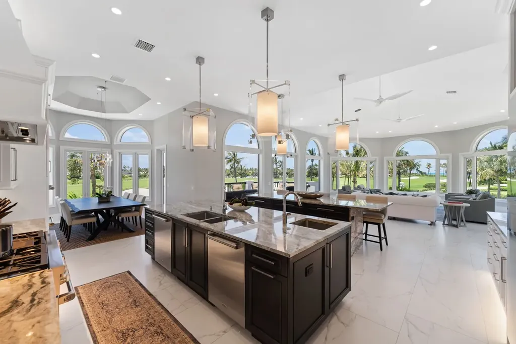 3057 SE Dune Drive Home in Stuart, Florida. Discover this artfully reimagined and fully renovated home boasting panoramic views of a Jack Nicklaus golf course, the lake, and the ocean. Flooded with natural light through 166 windows, the neutral palette accentuates exquisite finishes and architectural details. 