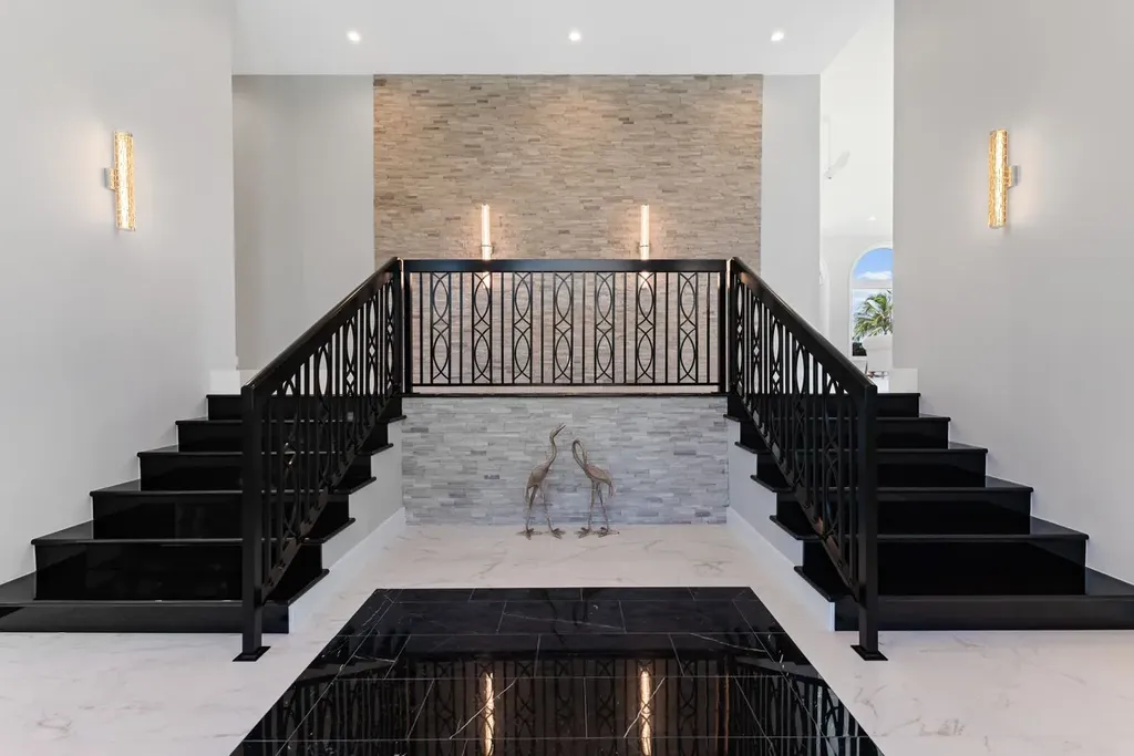 3057 SE Dune Drive Home in Stuart, Florida. Discover this artfully reimagined and fully renovated home boasting panoramic views of a Jack Nicklaus golf course, the lake, and the ocean. Flooded with natural light through 166 windows, the neutral palette accentuates exquisite finishes and architectural details. 