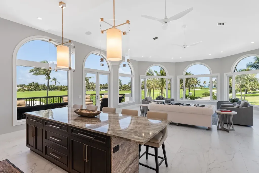 3057 SE Dune Drive Home in Stuart, Florida. Discover this artfully reimagined and fully renovated home boasting panoramic views of a Jack Nicklaus golf course, the lake, and the ocean. Flooded with natural light through 166 windows, the neutral palette accentuates exquisite finishes and architectural details. 