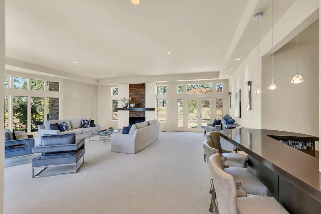4160 Marble Ridge Road Home in El Dorado Hills, California. Discover the extraordinary 10-acre hilltop estate offering breathtaking views and a resort-like experience. This stately home features massive floor-to-ceiling windows, an elegant living room with a full bar, and a modern great room with a gourmet kitchen.