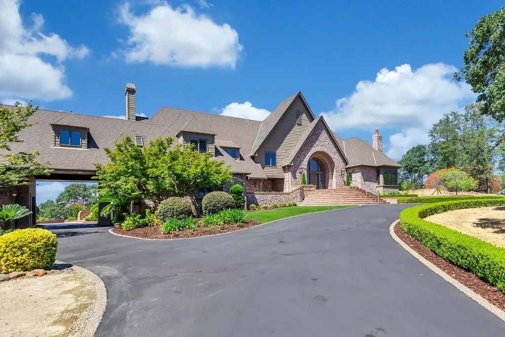 4160 Marble Ridge Road Home in El Dorado Hills, California. Discover the extraordinary 10-acre hilltop estate offering breathtaking views and a resort-like experience. This stately home features massive floor-to-ceiling windows, an elegant living room with a full bar, and a modern great room with a gourmet kitchen.