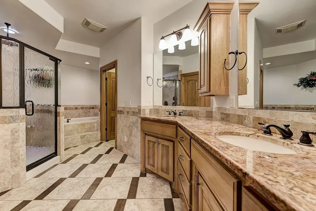 5001 Carrington Place Home in Oklahoma City, Oklahoma. Prepare to be entranced by the awe-inspiring surroundings of this exceptional estate, a harmonious blend of functionality, design, and unparalleled craftsmanship. From the moment you step inside, you'll be greeted by the elegance of quarter-sawn white oak doors, floors, and trim that evoke a sense of refined luxury.