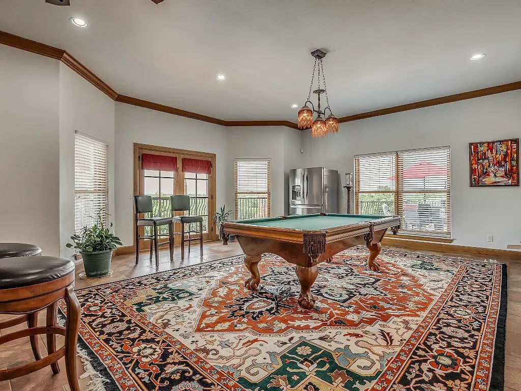 5001 Carrington Place Home in Oklahoma City, Oklahoma. Prepare to be entranced by the awe-inspiring surroundings of this exceptional estate, a harmonious blend of functionality, design, and unparalleled craftsmanship. From the moment you step inside, you'll be greeted by the elegance of quarter-sawn white oak doors, floors, and trim that evoke a sense of refined luxury.
