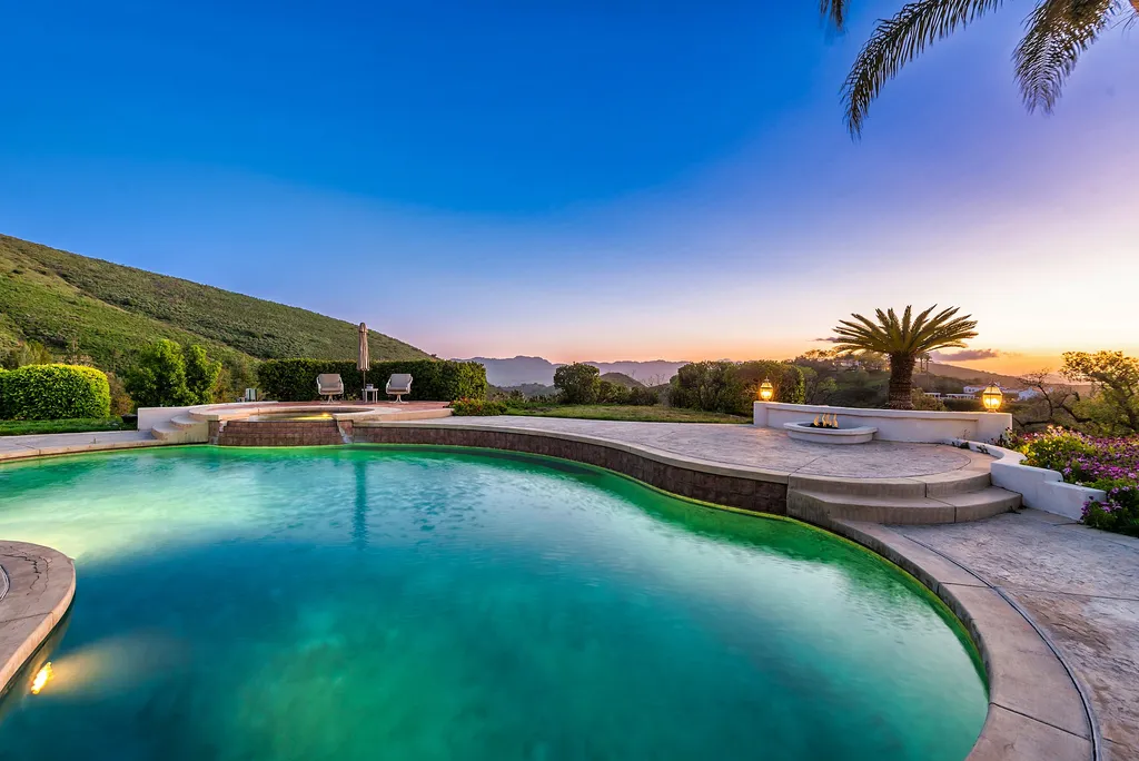 5063 Hunter Valley Lane Home in Westlake Village, California. Discover the epitome of luxury living in this epic Mediterranean compound, nestled on approximately 3.6 acres of prime land behind private gates in guard-gated North Ranch Country Club Estates. Enjoy complete privacy and breathtaking panoramic views from this approximately 9500 square foot hilltop estate.