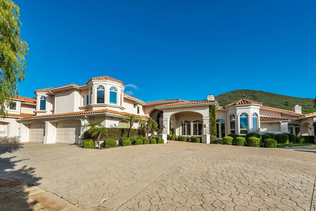 5063 Hunter Valley Lane Home in Westlake Village, California. Discover the epitome of luxury living in this epic Mediterranean compound, nestled on approximately 3.6 acres of prime land behind private gates in guard-gated North Ranch Country Club Estates. Enjoy complete privacy and breathtaking panoramic views from this approximately 9500 square foot hilltop estate.