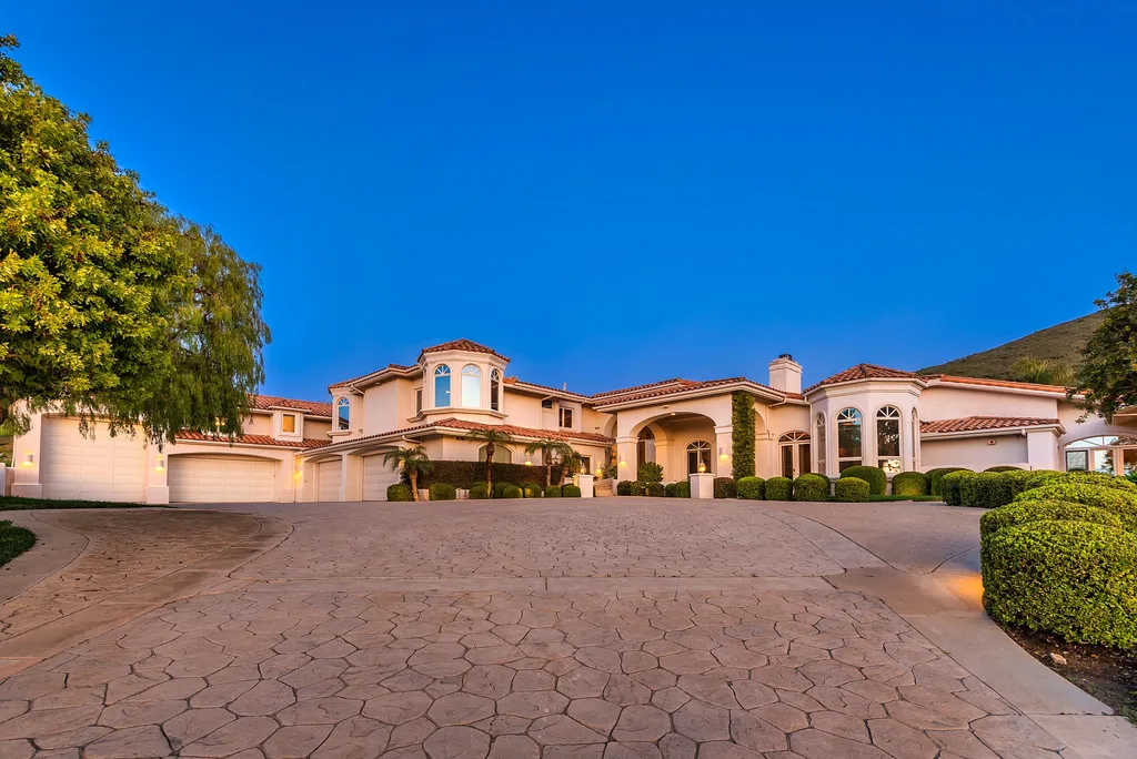 5063 Hunter Valley Lane Home in Westlake Village, California. Discover the epitome of luxury living in this epic Mediterranean compound, nestled on approximately 3.6 acres of prime land behind private gates in guard-gated North Ranch Country Club Estates. Enjoy complete privacy and breathtaking panoramic views from this approximately 9500 square foot hilltop estate.