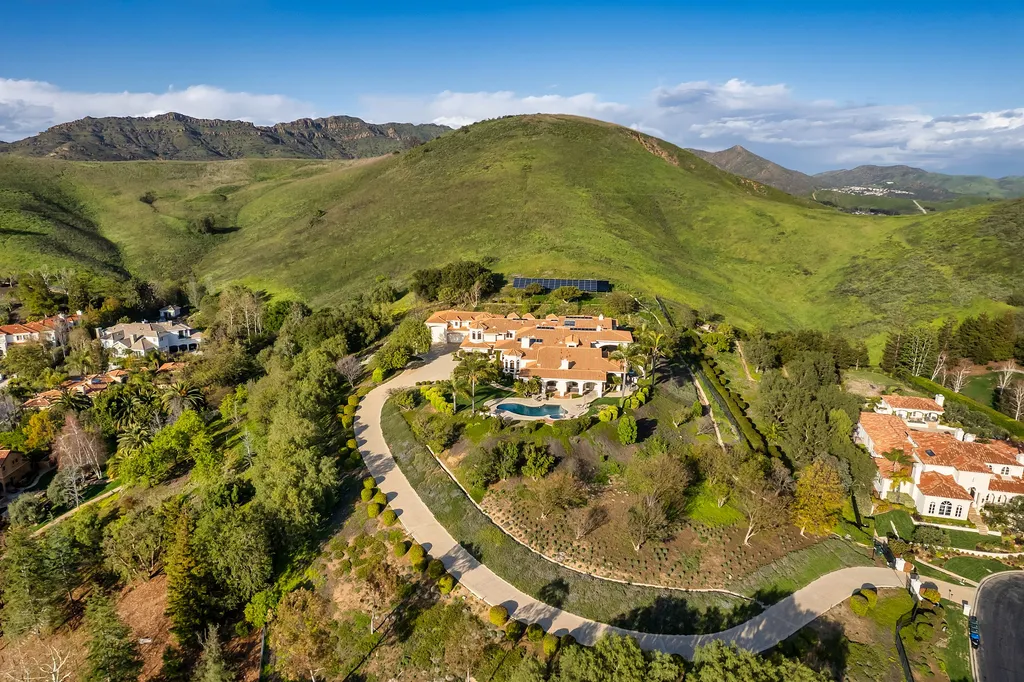 5063 Hunter Valley Lane Home in Westlake Village, California. Discover the epitome of luxury living in this epic Mediterranean compound, nestled on approximately 3.6 acres of prime land behind private gates in guard-gated North Ranch Country Club Estates. Enjoy complete privacy and breathtaking panoramic views from this approximately 9500 square foot hilltop estate.