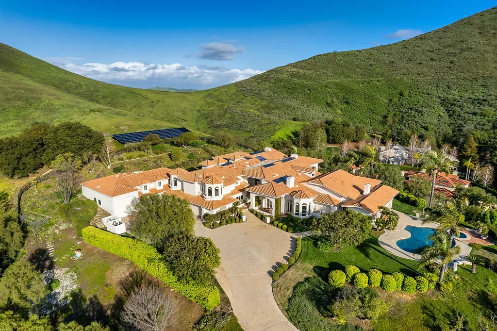 5063 Hunter Valley Lane Home in Westlake Village, California. Discover the epitome of luxury living in this epic Mediterranean compound, nestled on approximately 3.6 acres of prime land behind private gates in guard-gated North Ranch Country Club Estates. Enjoy complete privacy and breathtaking panoramic views from this approximately 9500 square foot hilltop estate.