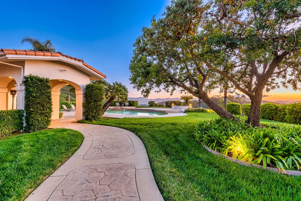5063 Hunter Valley Lane Home in Westlake Village, California. Discover the epitome of luxury living in this epic Mediterranean compound, nestled on approximately 3.6 acres of prime land behind private gates in guard-gated North Ranch Country Club Estates. Enjoy complete privacy and breathtaking panoramic views from this approximately 9500 square foot hilltop estate.