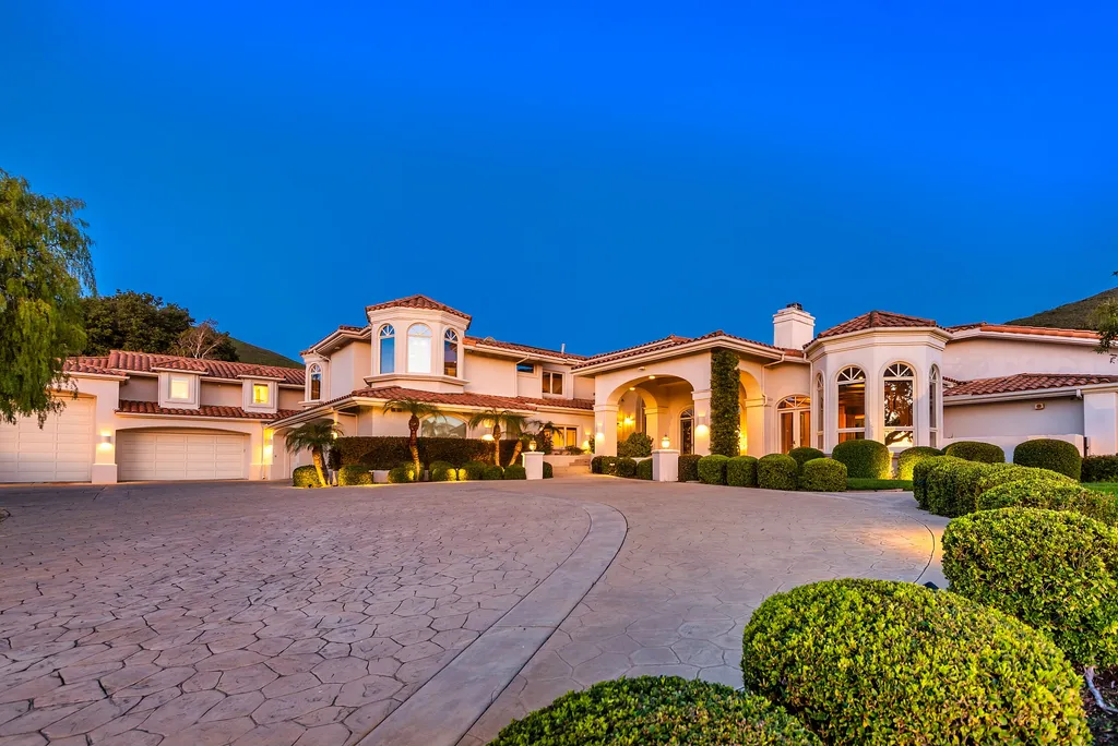 5063 Hunter Valley Lane Home in Westlake Village, California. Discover the epitome of luxury living in this epic Mediterranean compound, nestled on approximately 3.6 acres of prime land behind private gates in guard-gated North Ranch Country Club Estates. Enjoy complete privacy and breathtaking panoramic views from this approximately 9500 square foot hilltop estate.