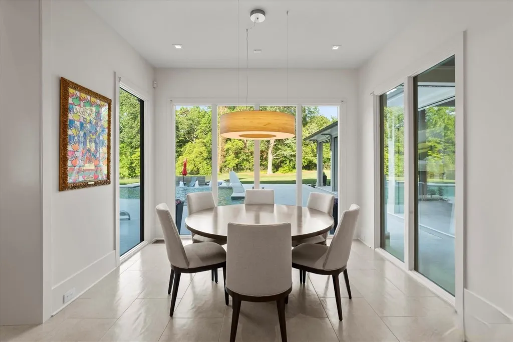 519 Brackenbury Lane Home in Charlotte, North Carolina. Discover a truly unique modern Kingswood Home built in 2019, an exquisite and meticulously designed residence that showcases the epitome of luxury living. With 7,491 square feet spread over 2 acres, this home boasts a custom curved stairwell by Artisan, a stunning glass refrigerated wine display room, and Walker Zanger light gray stone tile throughout the main and upper levels. 