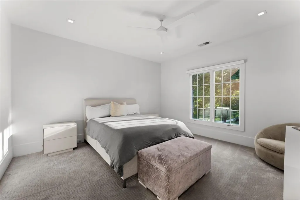 519 Brackenbury Lane Home in Charlotte, North Carolina. Discover a truly unique modern Kingswood Home built in 2019, an exquisite and meticulously designed residence that showcases the epitome of luxury living. With 7,491 square feet spread over 2 acres, this home boasts a custom curved stairwell by Artisan, a stunning glass refrigerated wine display room, and Walker Zanger light gray stone tile throughout the main and upper levels. 