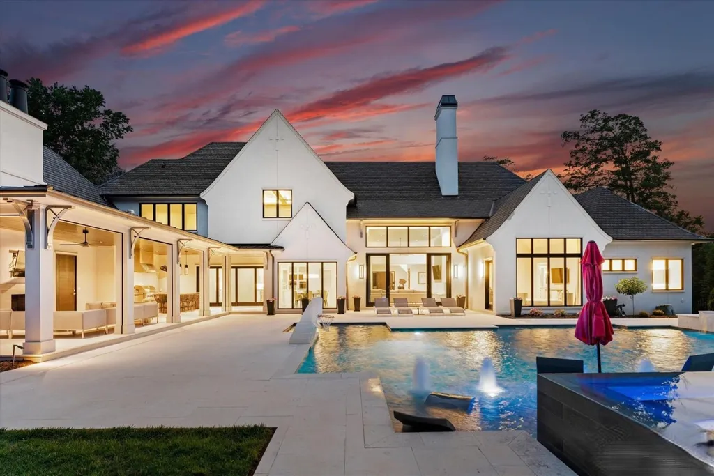 519 Brackenbury Lane Home in Charlotte, North Carolina. Discover a truly unique modern Kingswood Home built in 2019, an exquisite and meticulously designed residence that showcases the epitome of luxury living. With 7,491 square feet spread over 2 acres, this home boasts a custom curved stairwell by Artisan, a stunning glass refrigerated wine display room, and Walker Zanger light gray stone tile throughout the main and upper levels. 