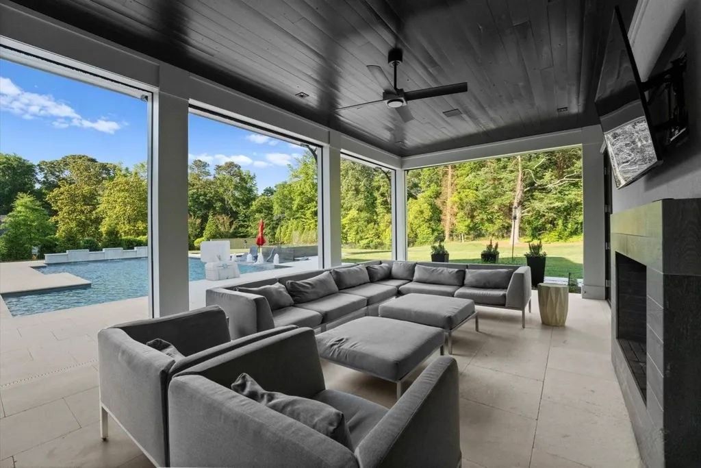 519 Brackenbury Lane Home in Charlotte, North Carolina. Discover a truly unique modern Kingswood Home built in 2019, an exquisite and meticulously designed residence that showcases the epitome of luxury living. With 7,491 square feet spread over 2 acres, this home boasts a custom curved stairwell by Artisan, a stunning glass refrigerated wine display room, and Walker Zanger light gray stone tile throughout the main and upper levels. 