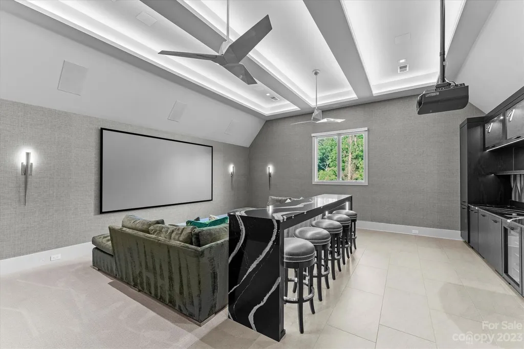 519 Brackenbury Lane Home in Charlotte, North Carolina. Discover a truly unique modern Kingswood Home built in 2019, an exquisite and meticulously designed residence that showcases the epitome of luxury living. With 7,491 square feet spread over 2 acres, this home boasts a custom curved stairwell by Artisan, a stunning glass refrigerated wine display room, and Walker Zanger light gray stone tile throughout the main and upper levels. 