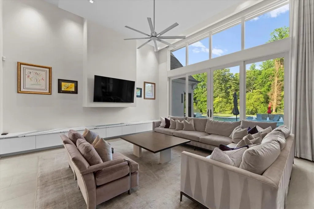 519 Brackenbury Lane Home in Charlotte, North Carolina. Discover a truly unique modern Kingswood Home built in 2019, an exquisite and meticulously designed residence that showcases the epitome of luxury living. With 7,491 square feet spread over 2 acres, this home boasts a custom curved stairwell by Artisan, a stunning glass refrigerated wine display room, and Walker Zanger light gray stone tile throughout the main and upper levels. 