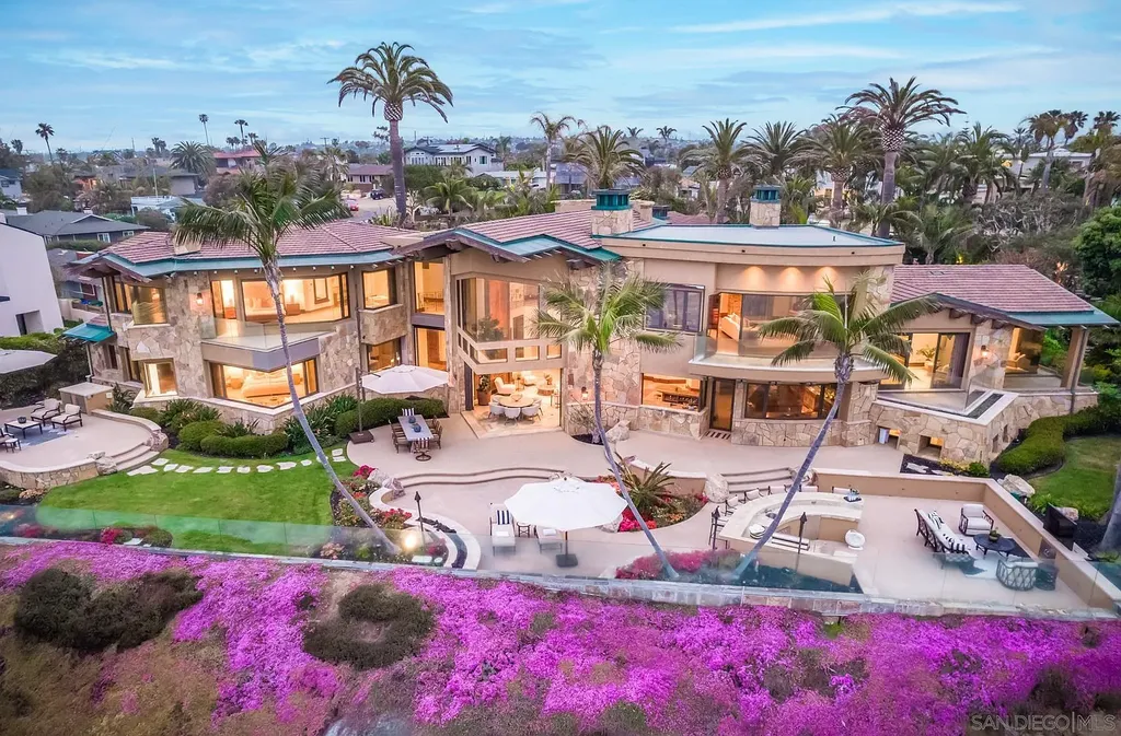 5305 Carlsbad Boulevard Home in Carlsbad, California. Experience the epitome of Southern California coastal living on this extraordinary 1.5-acre oceanfront property. With 165 feet of pristine coastline, panoramic Pacific Ocean views, private beach access, and stunning outdoor spaces, this 5-bedroom estate offers unparalleled luxury.