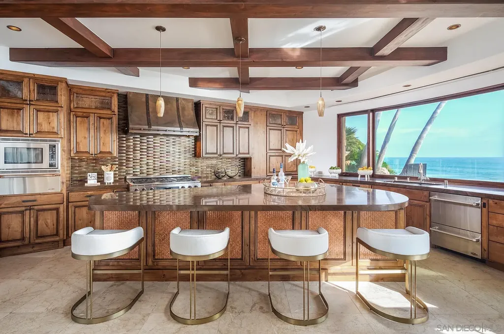 5305 Carlsbad Boulevard Home in Carlsbad, California. Experience the epitome of Southern California coastal living on this extraordinary 1.5-acre oceanfront property. With 165 feet of pristine coastline, panoramic Pacific Ocean views, private beach access, and stunning outdoor spaces, this 5-bedroom estate offers unparalleled luxury.