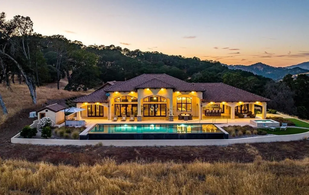 5343-5355 Suisun Valley Road Home in Fairfield, California. Stunning 20-acre hilltop compound in Fairfield boasts panoramic views of the valley, vineyards, and Mount Diablo. The Tuscan-inspired main house features cathedral ceilings, antique beams, and travertine flooring. The majestic living/dining great room has a fireplace and overlooks the pool, patio, and views. 