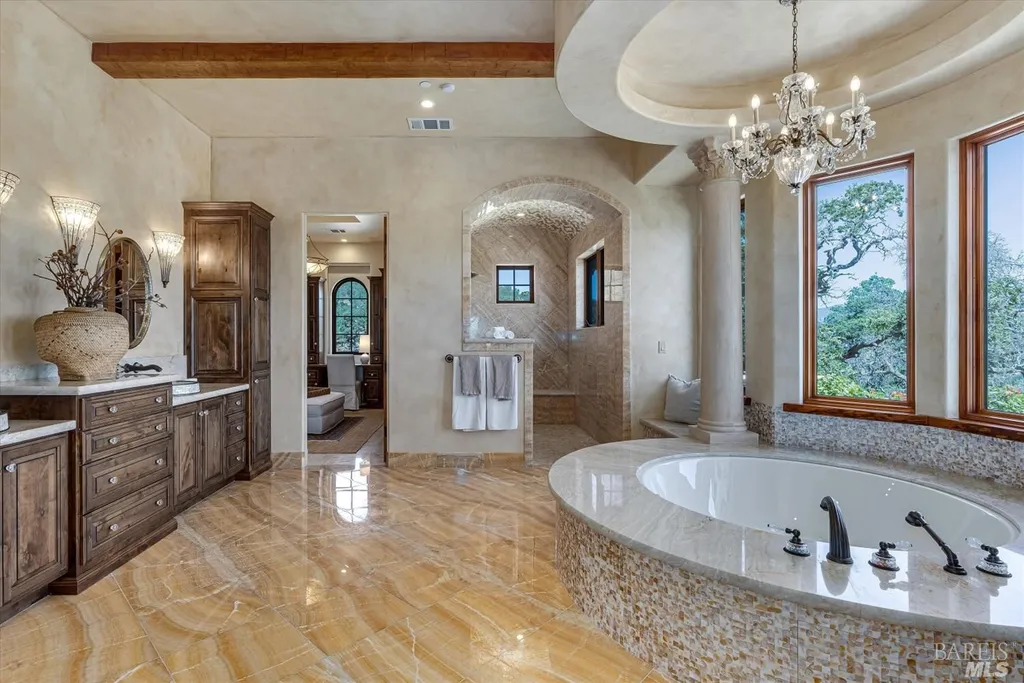 5343-5355 Suisun Valley Road Home in Fairfield, California. Stunning 20-acre hilltop compound in Fairfield boasts panoramic views of the valley, vineyards, and Mount Diablo. The Tuscan-inspired main house features cathedral ceilings, antique beams, and travertine flooring. The majestic living/dining great room has a fireplace and overlooks the pool, patio, and views. 