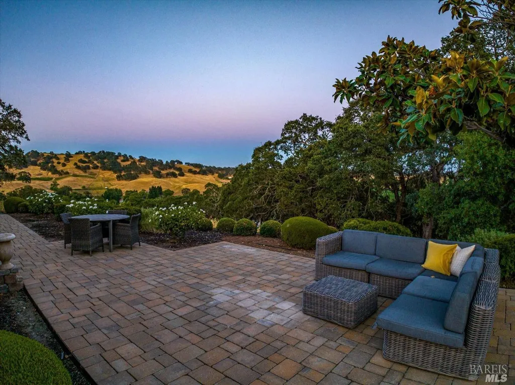 5343-5355 Suisun Valley Road Home in Fairfield, California. Stunning 20-acre hilltop compound in Fairfield boasts panoramic views of the valley, vineyards, and Mount Diablo. The Tuscan-inspired main house features cathedral ceilings, antique beams, and travertine flooring. The majestic living/dining great room has a fireplace and overlooks the pool, patio, and views. 