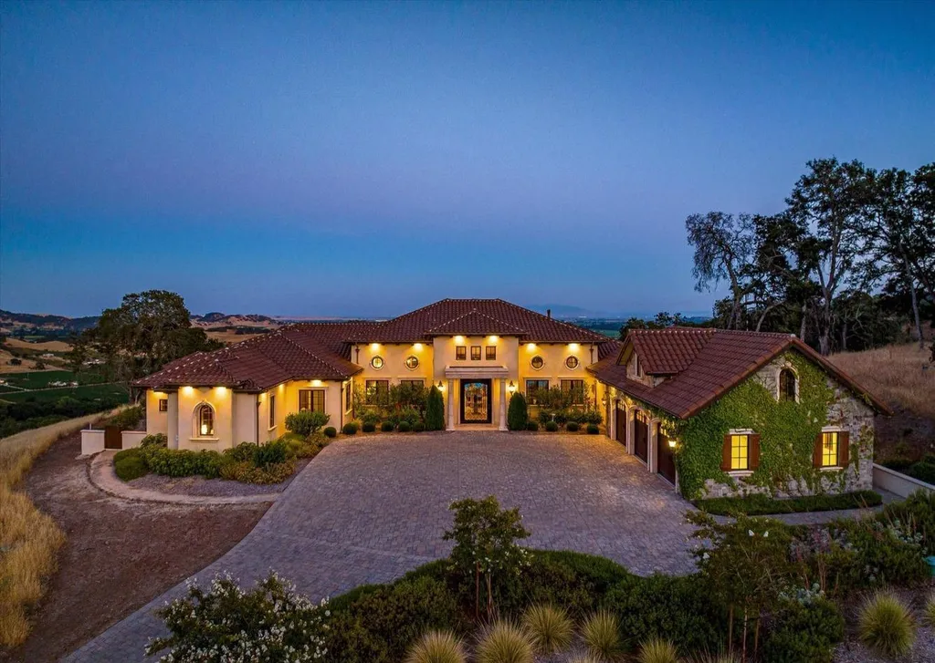 5343-5355 Suisun Valley Road Home in Fairfield, California. Stunning 20-acre hilltop compound in Fairfield boasts panoramic views of the valley, vineyards, and Mount Diablo. The Tuscan-inspired main house features cathedral ceilings, antique beams, and travertine flooring. The majestic living/dining great room has a fireplace and overlooks the pool, patio, and views. 
