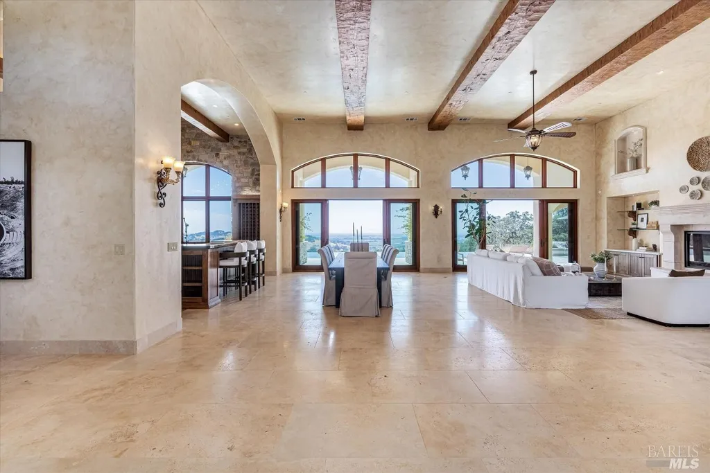 5343-5355 Suisun Valley Road Home in Fairfield, California. Stunning 20-acre hilltop compound in Fairfield boasts panoramic views of the valley, vineyards, and Mount Diablo. The Tuscan-inspired main house features cathedral ceilings, antique beams, and travertine flooring. The majestic living/dining great room has a fireplace and overlooks the pool, patio, and views. 