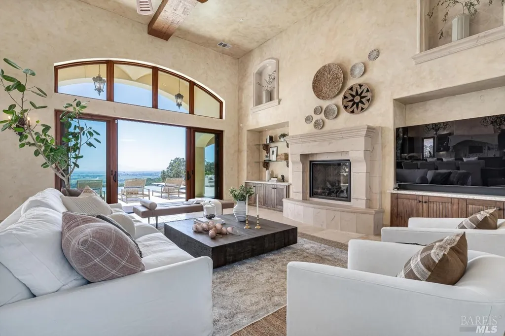 5343-5355 Suisun Valley Road Home in Fairfield, California. Stunning 20-acre hilltop compound in Fairfield boasts panoramic views of the valley, vineyards, and Mount Diablo. The Tuscan-inspired main house features cathedral ceilings, antique beams, and travertine flooring. The majestic living/dining great room has a fireplace and overlooks the pool, patio, and views. 