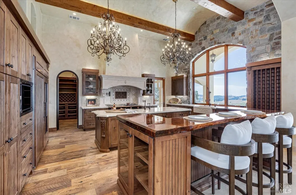 5343-5355 Suisun Valley Road Home in Fairfield, California. Stunning 20-acre hilltop compound in Fairfield boasts panoramic views of the valley, vineyards, and Mount Diablo. The Tuscan-inspired main house features cathedral ceilings, antique beams, and travertine flooring. The majestic living/dining great room has a fireplace and overlooks the pool, patio, and views. 