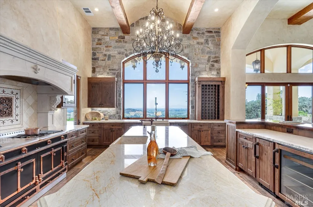 5343-5355 Suisun Valley Road Home in Fairfield, California. Stunning 20-acre hilltop compound in Fairfield boasts panoramic views of the valley, vineyards, and Mount Diablo. The Tuscan-inspired main house features cathedral ceilings, antique beams, and travertine flooring. The majestic living/dining great room has a fireplace and overlooks the pool, patio, and views. 
