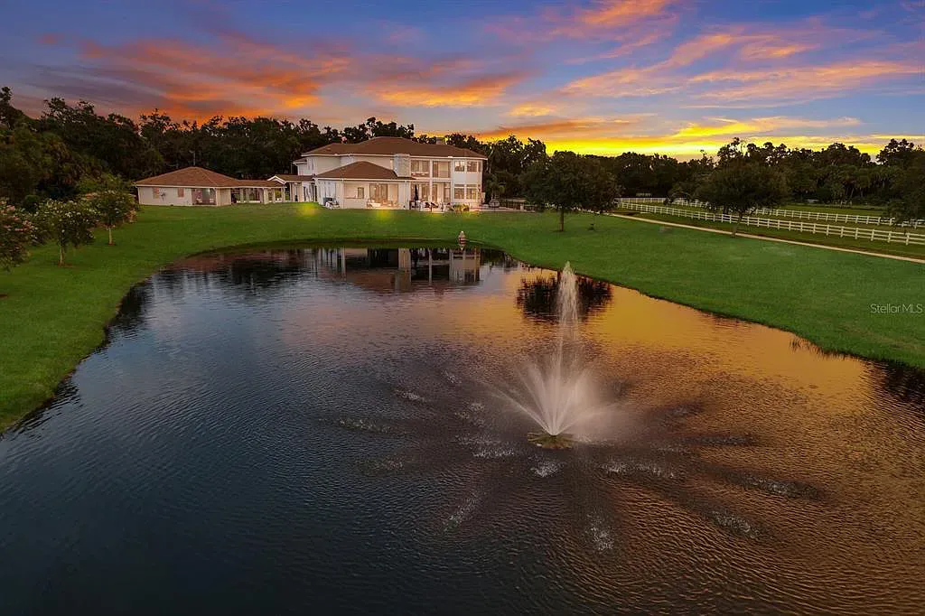 5952 Vanderipe Road Home in Sarasota, Florida. Discover luxurious country living at its finest in this custom-designed home nestled on a sprawling equestrian estate in Myakka Valley Ranches. With over 12 acres of land, two separate lots, and a meticulously crafted residence boasting modern amenities, this property offers a canvas for your dreams to flourish.