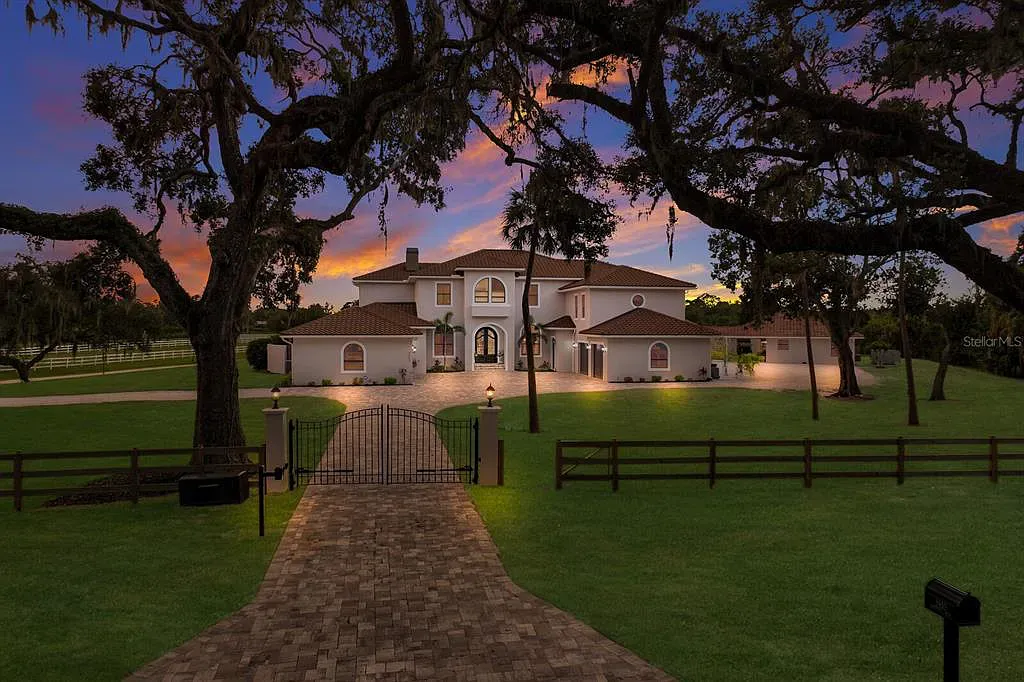 5952 Vanderipe Road Home in Sarasota, Florida. Discover luxurious country living at its finest in this custom-designed home nestled on a sprawling equestrian estate in Myakka Valley Ranches. With over 12 acres of land, two separate lots, and a meticulously crafted residence boasting modern amenities, this property offers a canvas for your dreams to flourish.