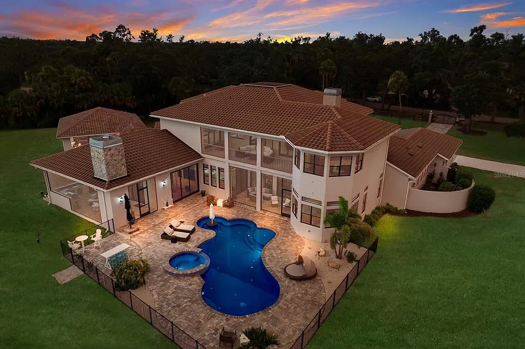 5952 Vanderipe Road Home in Sarasota, Florida. Discover luxurious country living at its finest in this custom-designed home nestled on a sprawling equestrian estate in Myakka Valley Ranches. With over 12 acres of land, two separate lots, and a meticulously crafted residence boasting modern amenities, this property offers a canvas for your dreams to flourish.