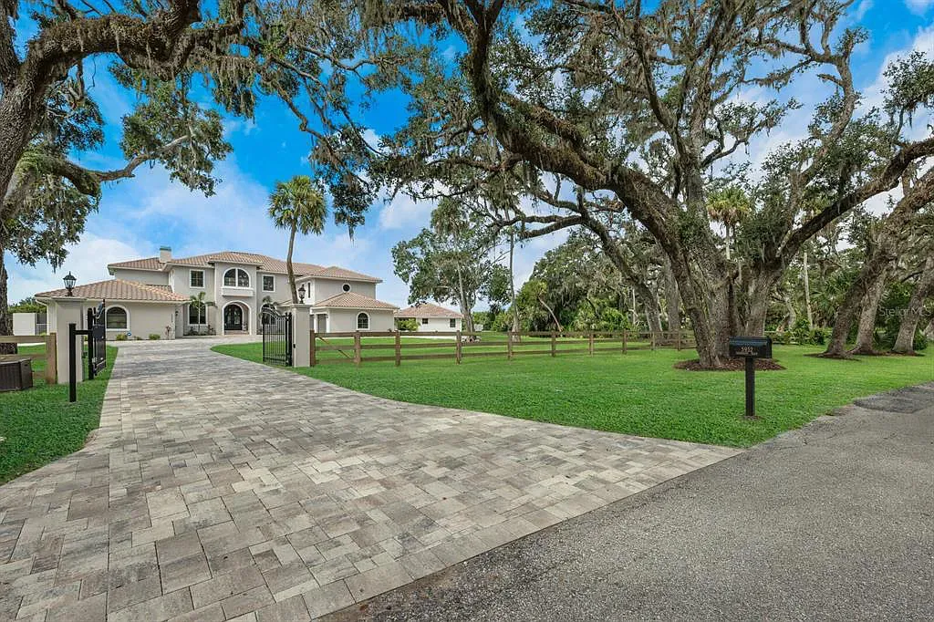 5952 Vanderipe Road Home in Sarasota, Florida. Discover luxurious country living at its finest in this custom-designed home nestled on a sprawling equestrian estate in Myakka Valley Ranches. With over 12 acres of land, two separate lots, and a meticulously crafted residence boasting modern amenities, this property offers a canvas for your dreams to flourish.
