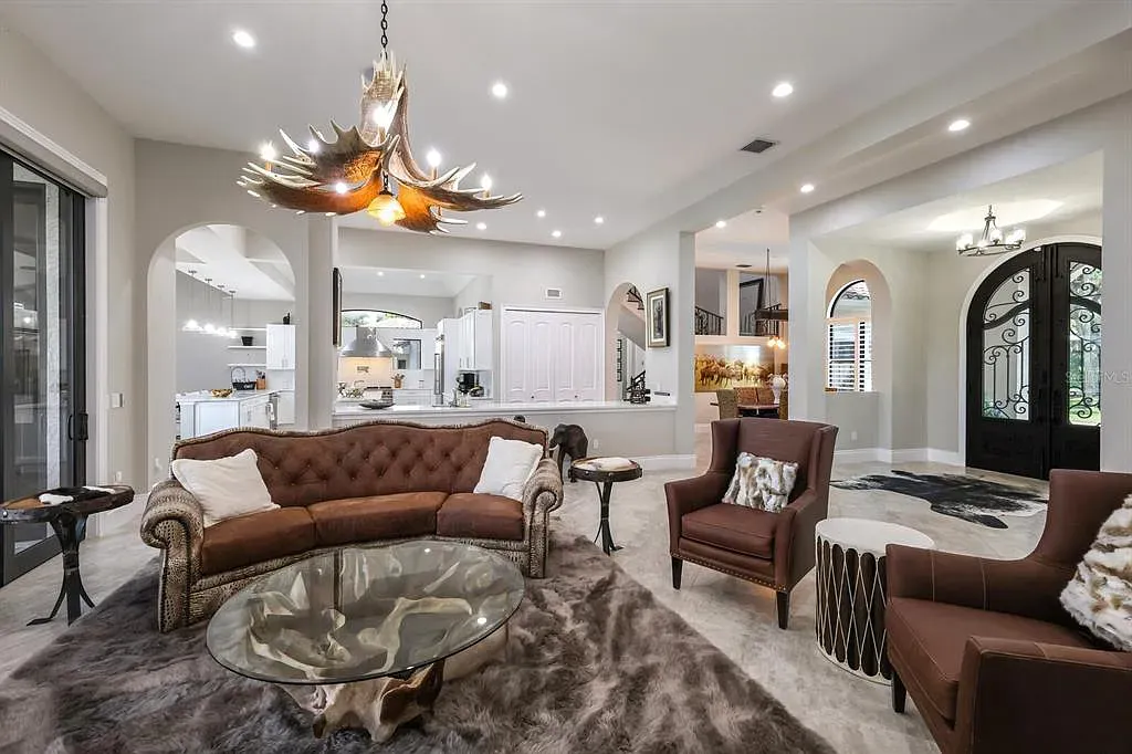5952 Vanderipe Road Home in Sarasota, Florida. Discover luxurious country living at its finest in this custom-designed home nestled on a sprawling equestrian estate in Myakka Valley Ranches. With over 12 acres of land, two separate lots, and a meticulously crafted residence boasting modern amenities, this property offers a canvas for your dreams to flourish.