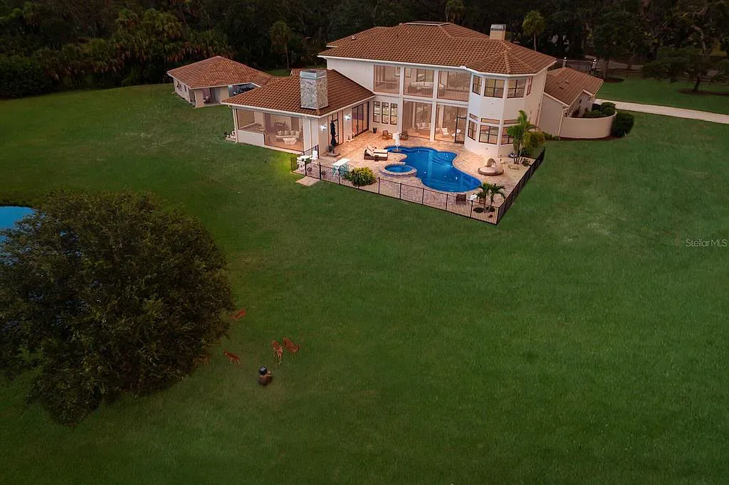 5952 Vanderipe Road Home in Sarasota, Florida. Discover luxurious country living at its finest in this custom-designed home nestled on a sprawling equestrian estate in Myakka Valley Ranches. With over 12 acres of land, two separate lots, and a meticulously crafted residence boasting modern amenities, this property offers a canvas for your dreams to flourish.