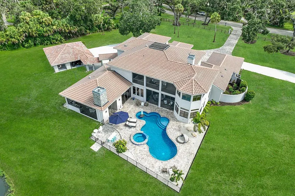 5952 Vanderipe Road Home in Sarasota, Florida. Discover luxurious country living at its finest in this custom-designed home nestled on a sprawling equestrian estate in Myakka Valley Ranches. With over 12 acres of land, two separate lots, and a meticulously crafted residence boasting modern amenities, this property offers a canvas for your dreams to flourish.